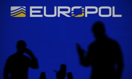 A Europol sign and some shadowy figures