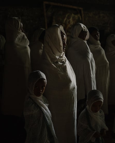 A mother and her two children pray