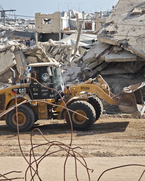 Small child and yellow bulldozer with collapsed buildings in backdrop and rebar in foreground