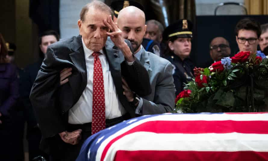 Dole salutes the casket of the late George HW Bush, at the US Capitol in December 2018.