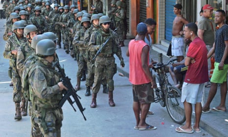 Police personnel in combat gear are seen at Rocinha favela in Rio de Janeiro