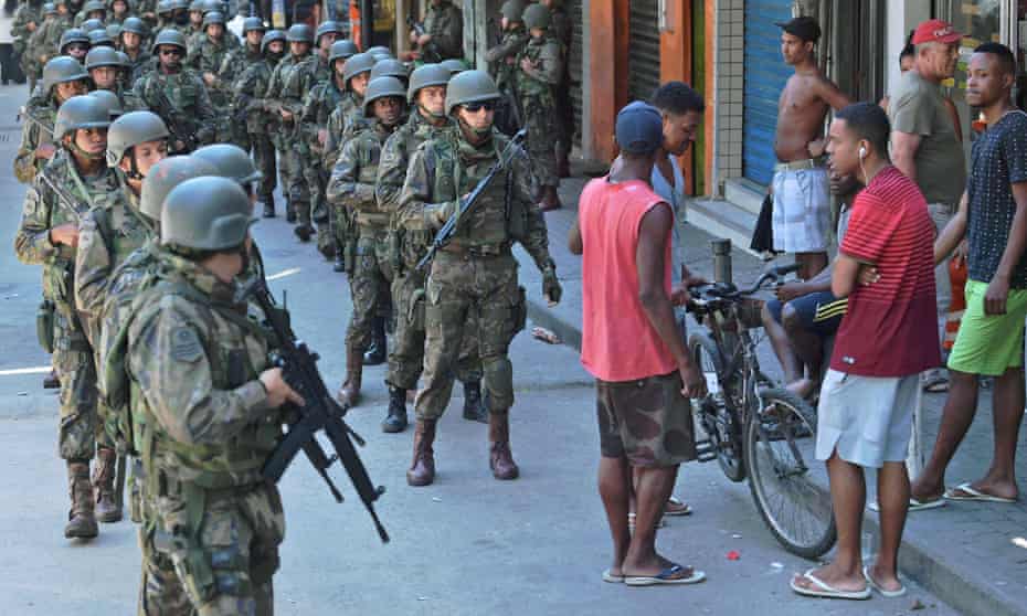 Police personnel in combat gear are seen at Rocinha favela in Rio de Janeiro