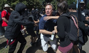 KCRA television reporter Mike Luery runs away from members of Antifa Sacramento, who staged a counter-protest against the Traditionalist Worker party and the Golden State Skinheads, in Sacramento, California on 26 June 2016.