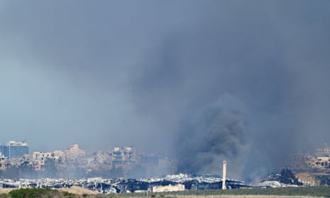 Distant view of smoke rising above buildings