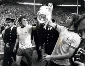 Kennedy holding the FA Cup aloft with Charlie George after Arsenal's 2-1 win against Liverpool