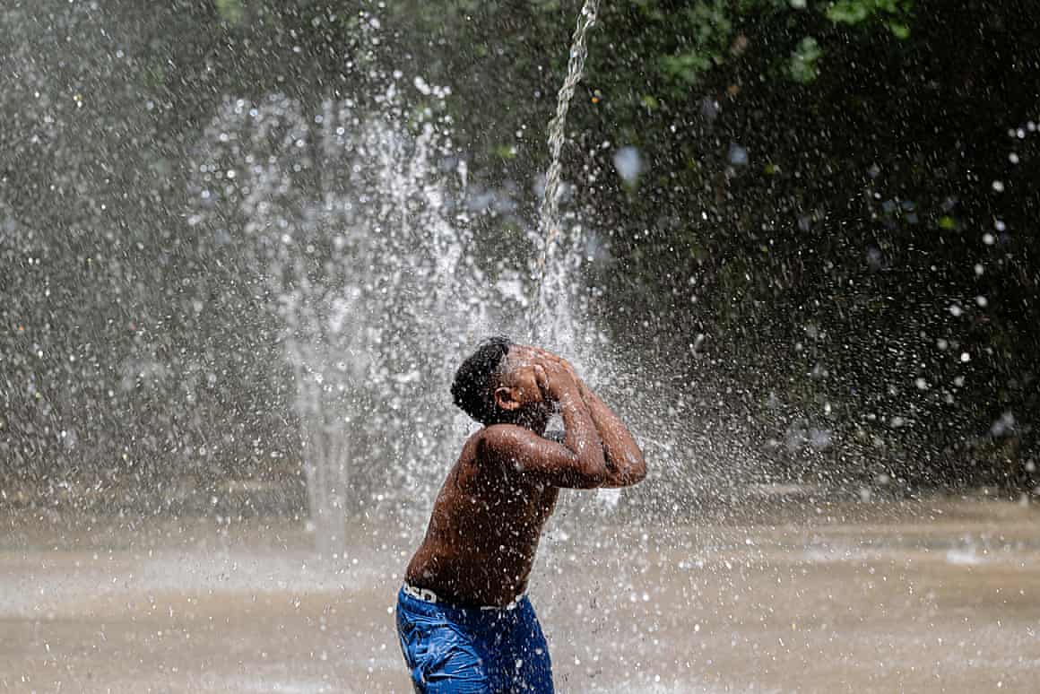a child in a water fountain