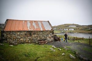 Alexander MacLeod outside a run-down stone outbuilding