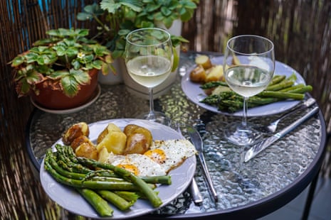 Fresh asparagus with young boiled potatoes, fried egg and glass of white wine. A delicious summer vegetarian meal: fresh asparagus with young boiled potatoes, fried egg and glass of white wine