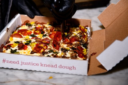 Chef Michael Carter slices a ‘What We Do’ pizza at Down North Pizza in Philadelphia.