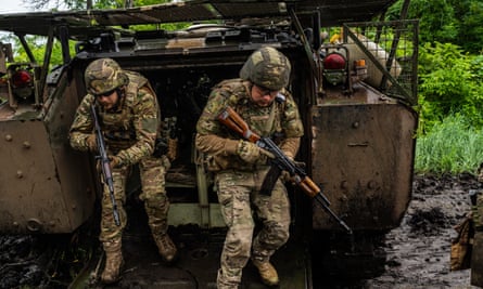 Soldiers emerging from an ageing US-made armoured personnel carrier