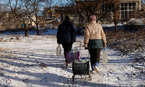 People return to their shelters after gathering water, as Russia's attack on Ukraine continues, in Siversk, Ukraine.