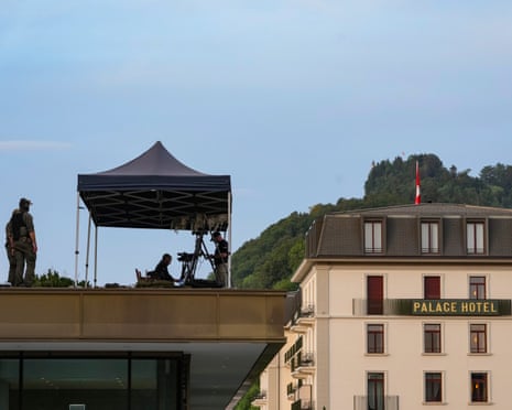 US secret service counter-snipers stand guard on a roof during the first day of peace talks at Lake Lucern in Switzerland
