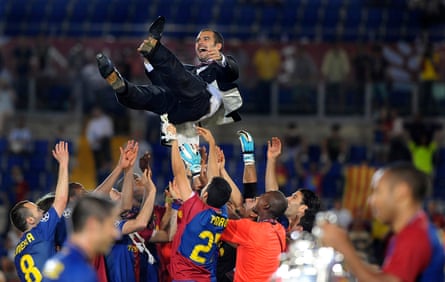 Pep Guardiola is thrown by Barcelona’s players as in the foreground Sylvinho and Henry look at the Champions League trophy in 2009.