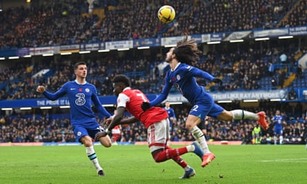 Arsenal midfielder Bukayo Saka falls under pressure from Marc Cucurella. Saka was accused of a dive by the Chelsea manager.