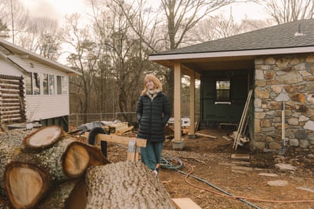 Homeowner Sari Bellmer stands in her front yard where a 70-year-old red oak fell on top of the house during the hurricane.