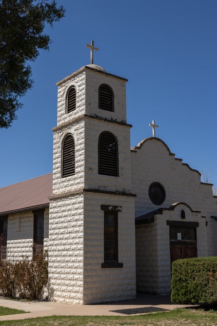 exterior of church with tower and cross on top