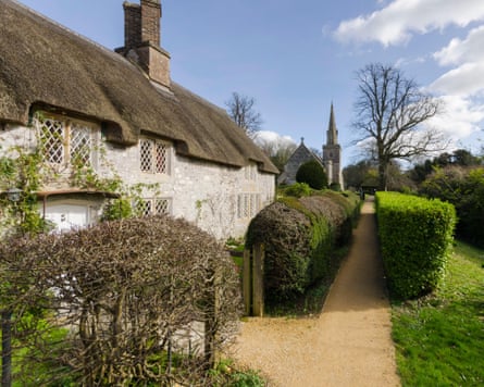 A thatched house in the village of Littlebredy on the Bridehead Estate, Dorset.