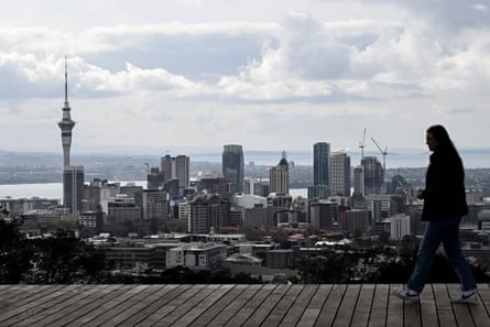 A tourist visiting Maungawhau/Mount Eden, the highest natural point in Auckland, with views of the city