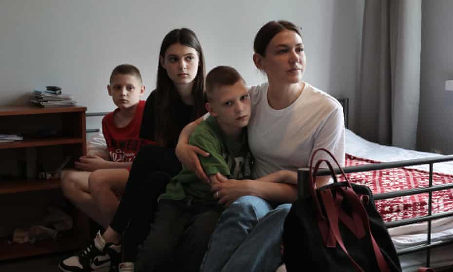 Iryna and her children on bed