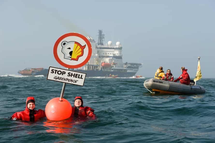 Greenpeace activists swim with buoys in front of the Finnish icebreaker ‘Nordica’ in the Baltic Sea close to Fehmarn Island. They are protesting against the ship heading for Shell’s Arctic oil drilling project in the north of Alaska. A sign on the buoy with an altered Shell logo reads “Stop Shell.”