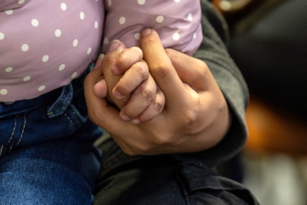 child holding an adult’s hand