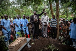 Mourners attend the burial of an 11-month-old girl who died in the town of Rutshuru, North Kivu province, during the Ebola outbreak in February 2020