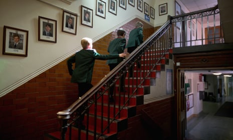 Pupils make their way to class past photographs of former headboys at Altrincham Grammar School for Boys