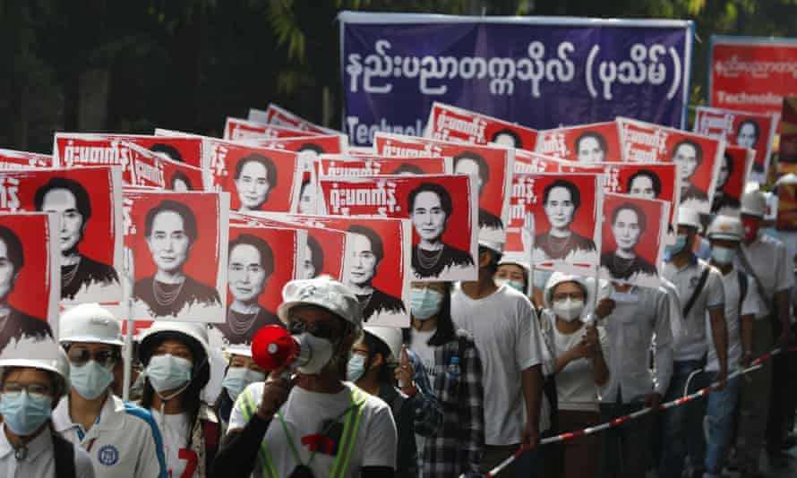 Protesters hold placards calling for the release of detained civilian leader Aung San Suu Kyi on Saturday in Yangon.