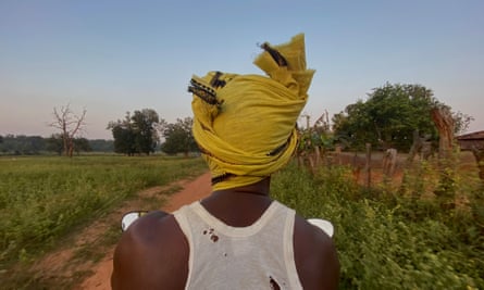 An Adivasi man on his motorbike near Ghatburra village