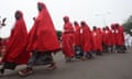 A line of women wearing red robes.