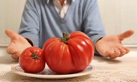 Man shows off big tomato