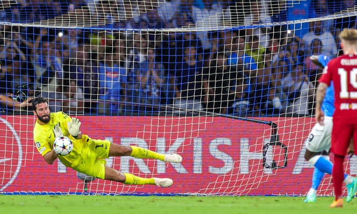 Liverpool keeper Alisson Becker saves the penalty from Victor Osimhen of Napoli.