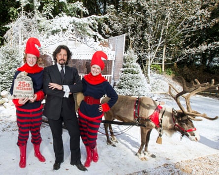 Laurence Llewelyn-Bowen and two elves with a reindeer