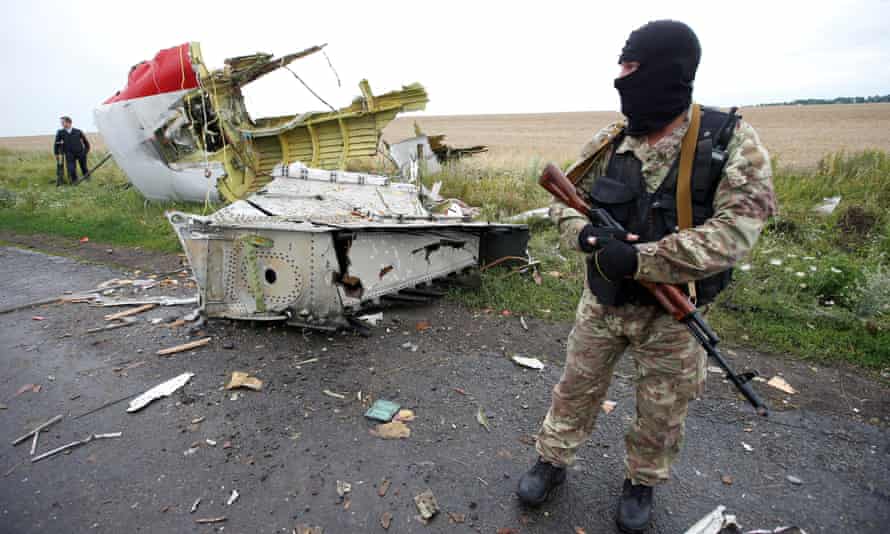 A pro-Russian separatist stands at the MH17 crash site in July 2014