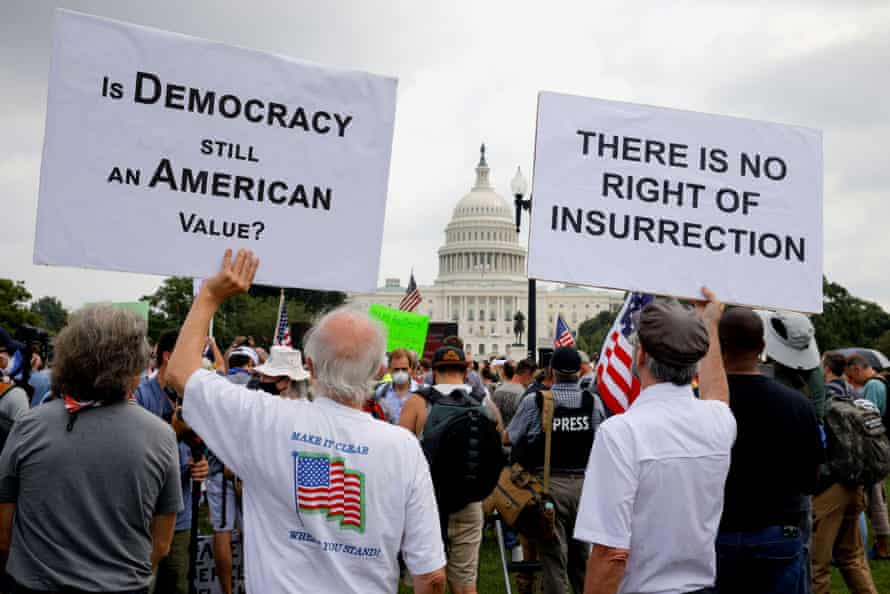 Counter-protesters hold signs during the Justice for J6 rally in Washington DC.