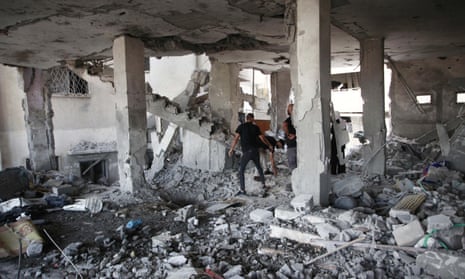 People look at the damage inside a building in the occupied West Bank city of Jenin, following an Israeli air strike on Sunday.