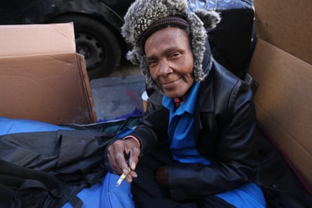Coy Catley, 63, in her homeless box made of cardboard sheets on a sidewalk of Tenderloin, San Francisco.