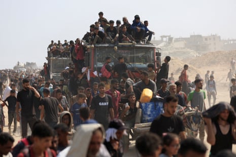 Palestinians seek aid supplies from trucks that entered Gaza through Israel.