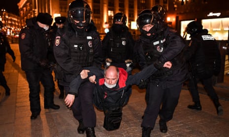 Police officers detain a man during a protest against Russia's invasion of Ukraine in central Moscow on Thursday.