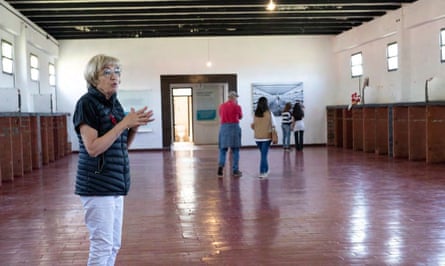 a woman stands in a large room