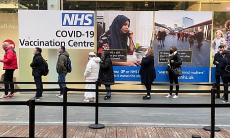 People queuing outside a Covid vaccination centre in London
