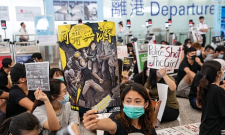 protesters in the departure hall of Hong Kong international airport on 13 August