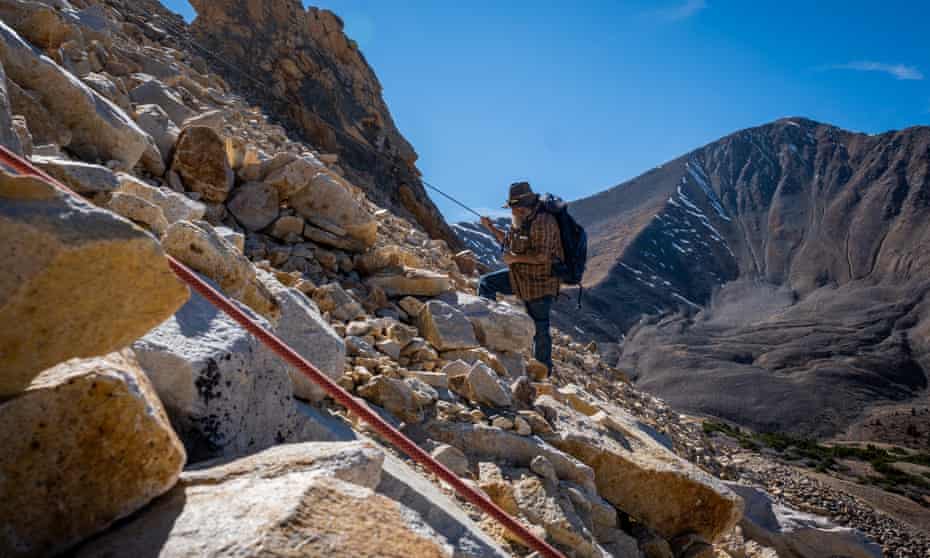 Brian Busse climbs upslope on loose rocks at his 11,500 foot high aquamarine mining claim on Mount Antero, Colorado.