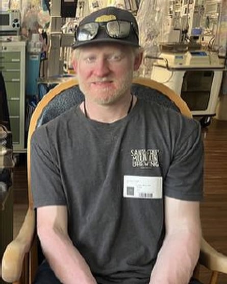 A man in a ball cap and blond beard.