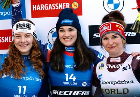 Summer Britcher, center, celebrates with second place finisher Lisa Schulte of Austria, left, and third place finisher Julia Taubitz of Germany after Sunday’s event.