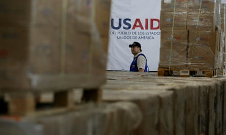 A man walks past boxes of USAid humanitarian aid at a warehouse on the outskirts of Cúcuta, Colombia, in 2019.