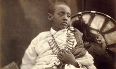 A miserable-looking child, Alemayehu, with one hand clutching his necklace
