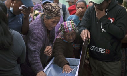 Relatives pay their last respects to a victim of the landslide.
