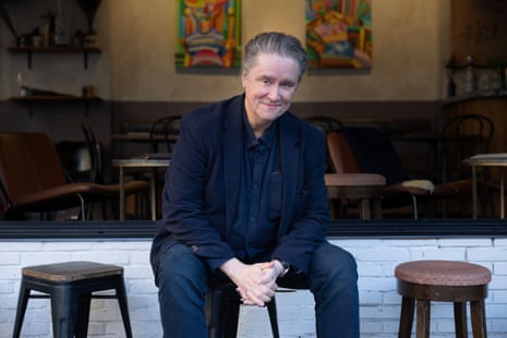 Fidler sits outside a cafe