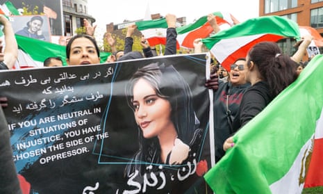 About 200 protesters demonstrate with flags against the Iranian government in Manchester in September 2022. They chanted the name of Mahsa Amini, a Kurdish woman who died in Iranian police custody after being arrested for not covering her hair.